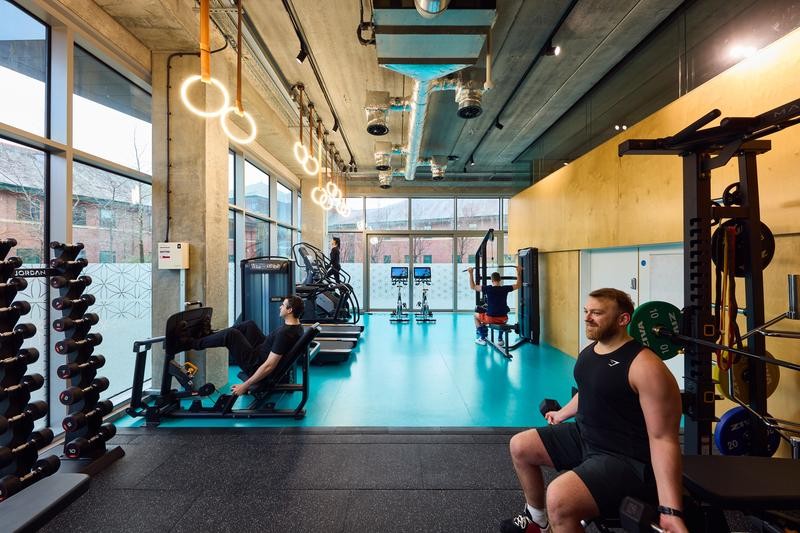 Fitness Suite gym space with people working out on different equipment