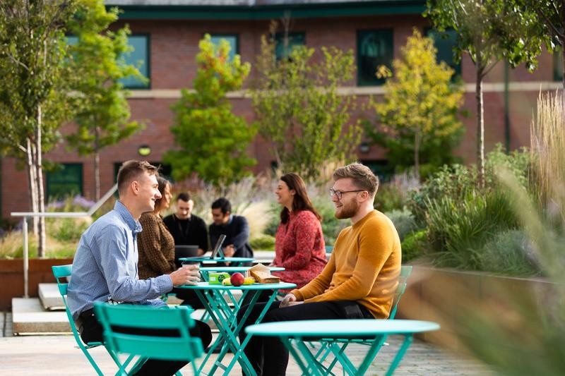 Outdoor Breakout Space MSP people sat on tables outside